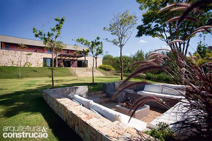 Ao instalar a construção no ponto mais alto do lote, o projeto conquistou melhor vista para todos os ambientes. Nas noites frias, este recanto ao ar livre conta com o calor da lareira, ao centro. (Marco Antonio)